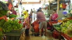 Typical late morning at the same market with people of different backgrounds negotiating the narrow spaces.