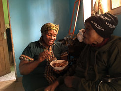 Grace feeding her mother in Bafoussam, Cameroon (2020). Photo: Nele Wolter.